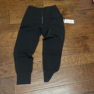 Varley black Duxford pant. Zippered front, details available.